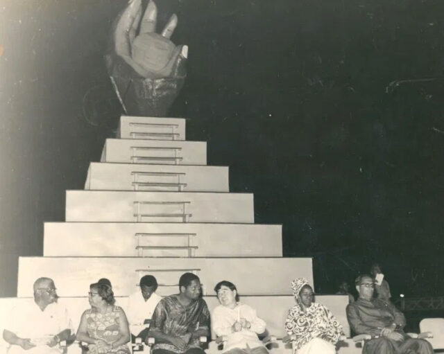 At the closing ceremony of CARIFESTA 1972 is the CARIFESTA logo – a dark hand grasping the sun, depicting the skills and aspirations of the tropical man with talent untold’. In the foreground are (second and third from left respectively) then Prime Minister of Guyana, Linden Forbes Sampson Burnham and then President of Guyana, Arthur Chung.